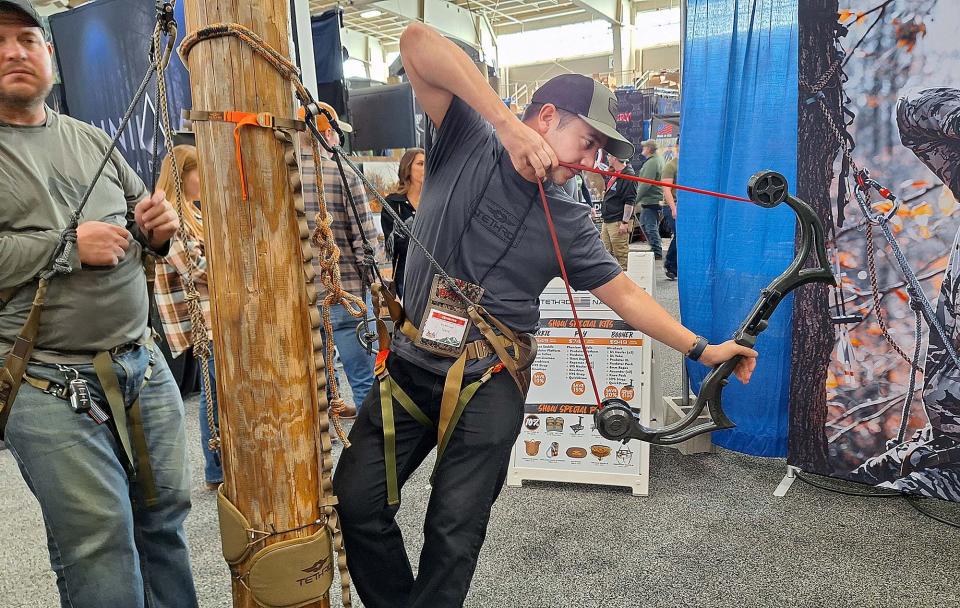 Robert Mendoza of Tethrd Nation demonstrates what it's like to archery hunt from a saddle during the Great American Outdoor Show in Harrisburg.