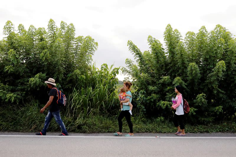 FILE PHOTO: Honduran migrants trying to reach the U.S. walk along a road as they move towards the Mexico border, in San Pedro Cadenas
