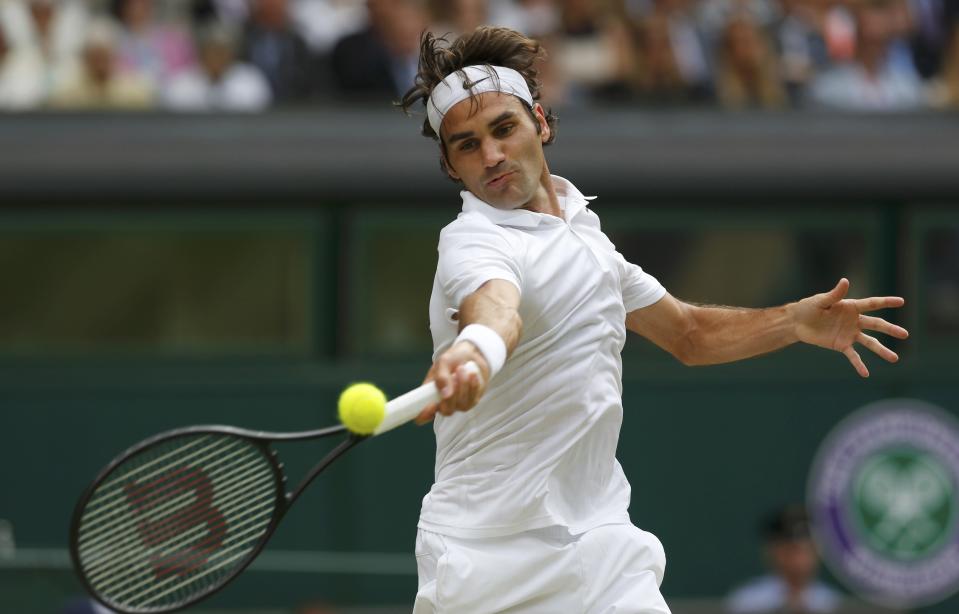Roger Federer of Switzerland hits a return during his men's singles final tennis match against Novak Djokovic of Serbia at the Wimbledon Tennis Championships, in London July 6, 2014. REUTERS/Stefan Wermuth