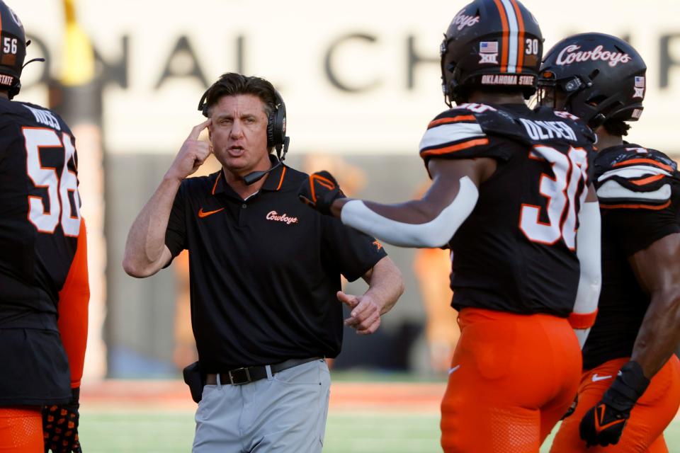 OSU football coach Mike Gundy talks to his team during a 27-24 win against OU on Saturday at Boone Pickens Stadium in Stillwater.