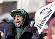 A Seattle Seahawks fan begins a "Sea-Hawks" cheer while waiting the parade for the Super Bowl champions Wednesday, Feb. 5, 2014, in Seattle. The Seahawks beat the Denver Broncos 43-8 in NFL football's Super Bowl XLVIII on Sunday. (AP Photo/Elaine Thompson)