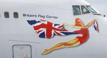 A member of the flight crew waves out of the window of Virgin Atlantic's penultimate Boeing 747-400 aircraft 'Forever Young' as it departs for the final time before being retired from the fleet at Manchester Airport, Britain