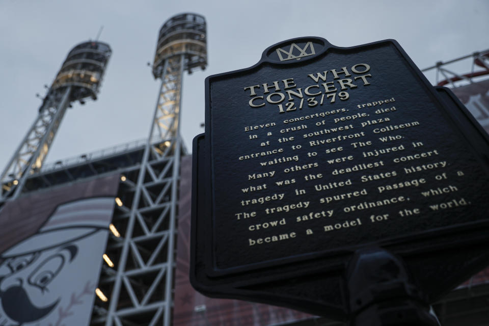 In this Wednesday, Nov. 20, 2019 photo, a memorial plaque for eleven concertgoers killed at a 1979 concert stands between Great American Ballpark and Heritage Bank Arena, in Cincinnati. Tragedy four decades ago linked the British rock band The Who to a small suburban city in Ohio. In recent years, members of the community and the band have bonded through a project to memorialize the three teens from Finneytown who were killed in a frantic stampede of people trying to get into The Who’s Dec. 3, 1979, Cincinnati concert. (AP Photo/John Minchillo)