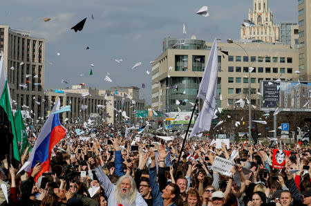 FILE PHOTO: People release paper planes, symbol of the Telegram messenger, during a rally in protest against court decision to block the messenger because it violated Russian regulations, in Moscow, Russia, April 30, 2018. REUTERS/Tatyana Makeyeva/File Photo