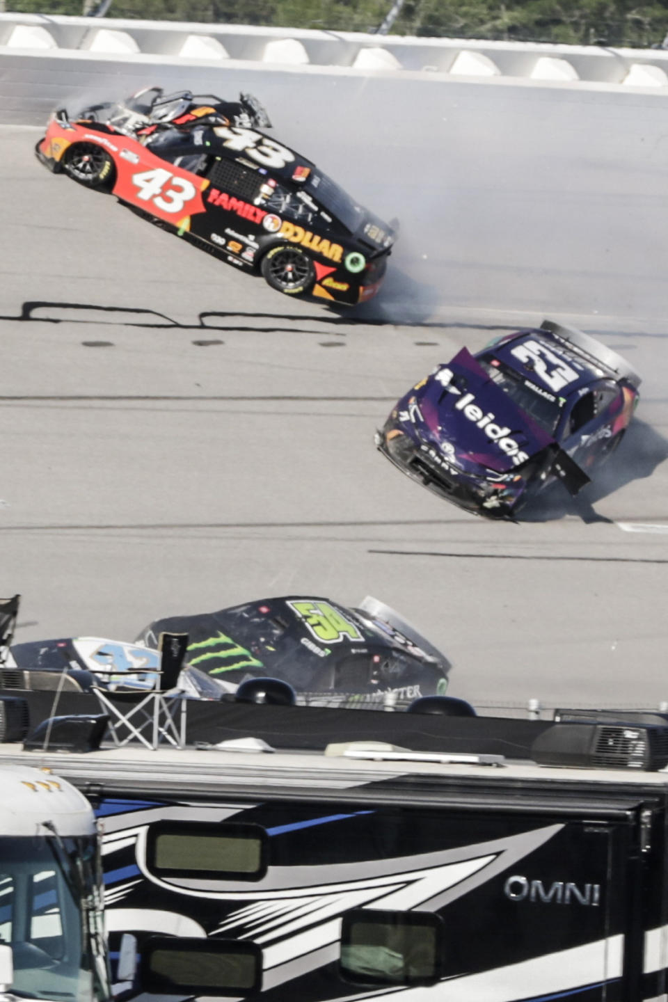 NASCAR Cup Series driver Erik Jones (43) collides driver Bubba Wallace (23) during a NASCAR Cup Series auto race at Talladega Superspeedway, Sunday, April 21, 2024, in Talladega. Ala. (AP Photo/Russell Norris)