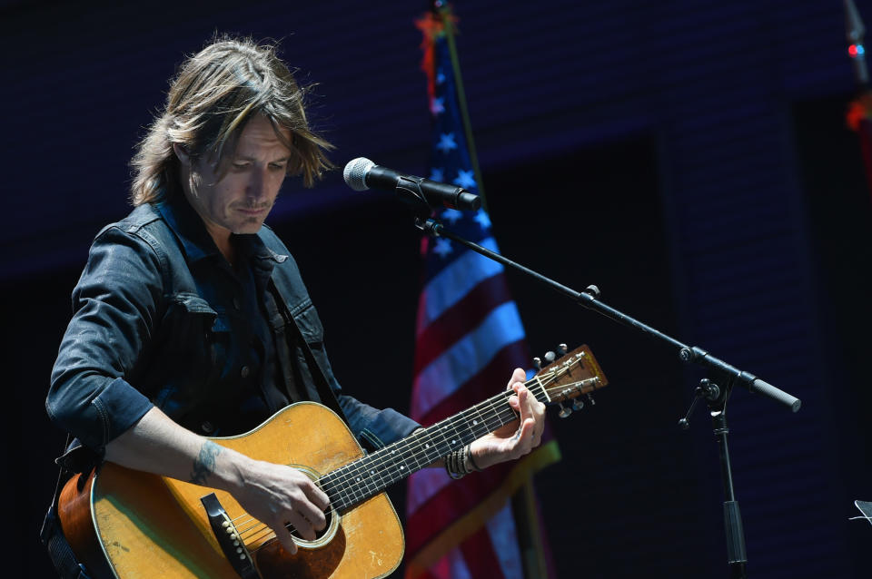 On Monday night, country music singer Keith Urban performed at a Nashville vigil for the victims of the Las Vegas shooting the night before. Urban told the crowd he was grateful to "put some light in the world." (Photo: Rick Diamond via Getty Images)