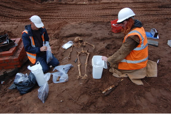 Archaeologists excavate a grave near Lichfield Cathedral. Most of the remains of the people in the graves show that the individuals were buried lying on their backs.