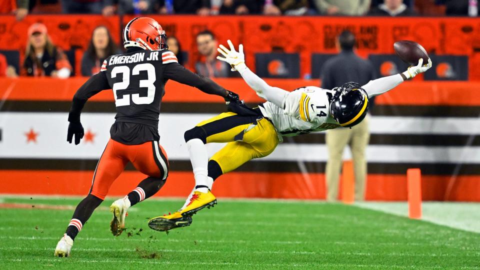 Steelers wide receiver George Pickens (14) makes a one-handed catch with Browns cornerback Martin Emerson Jr. (23) defending during the first half in Cleveland, Thursday, Sept. 22, 2022.