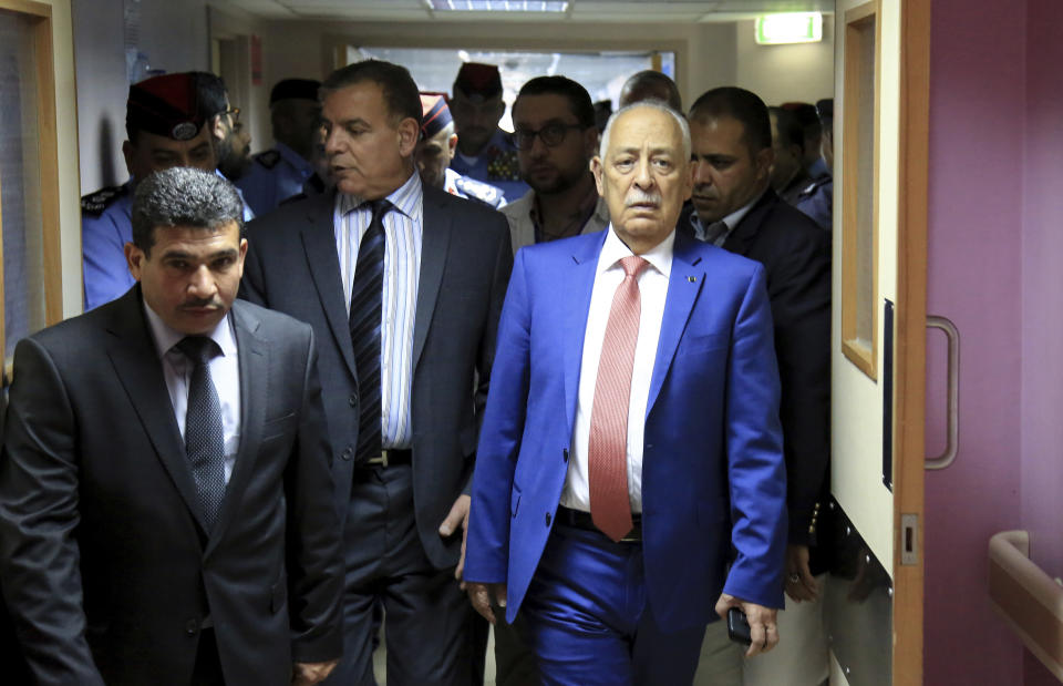 CORRECTS LOCATION OF HOSPITAL TO JERAASH - Royal Court chief Yousef Issawi, walks in the hallway of a hospital while visiting some of the victims of a knife attack in Jeraash, Jordan on Wednesday, Nov. 6, 2019. A young man from a Palestinian refugee camp on Wednesday stabbed eight people, including four foreign tourists and their tour guide, at a popular archaeological site in Jeraash, in northern Jordan, security officials said. The wounded included three Mexican tourists and a Swiss woman, according to Jordan's Public Security office. Along with the tour guide, three other Jordanians, including two security officers and a bus driver, were also hurt before the attacker was subdued and arrested. (AP Photo/Raad Adayleh)