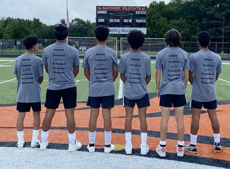 Members of the Gardner High boys soccer team model the warm-up T-shirts the team created to celebrate the multicultural diversity present on this year's roster.