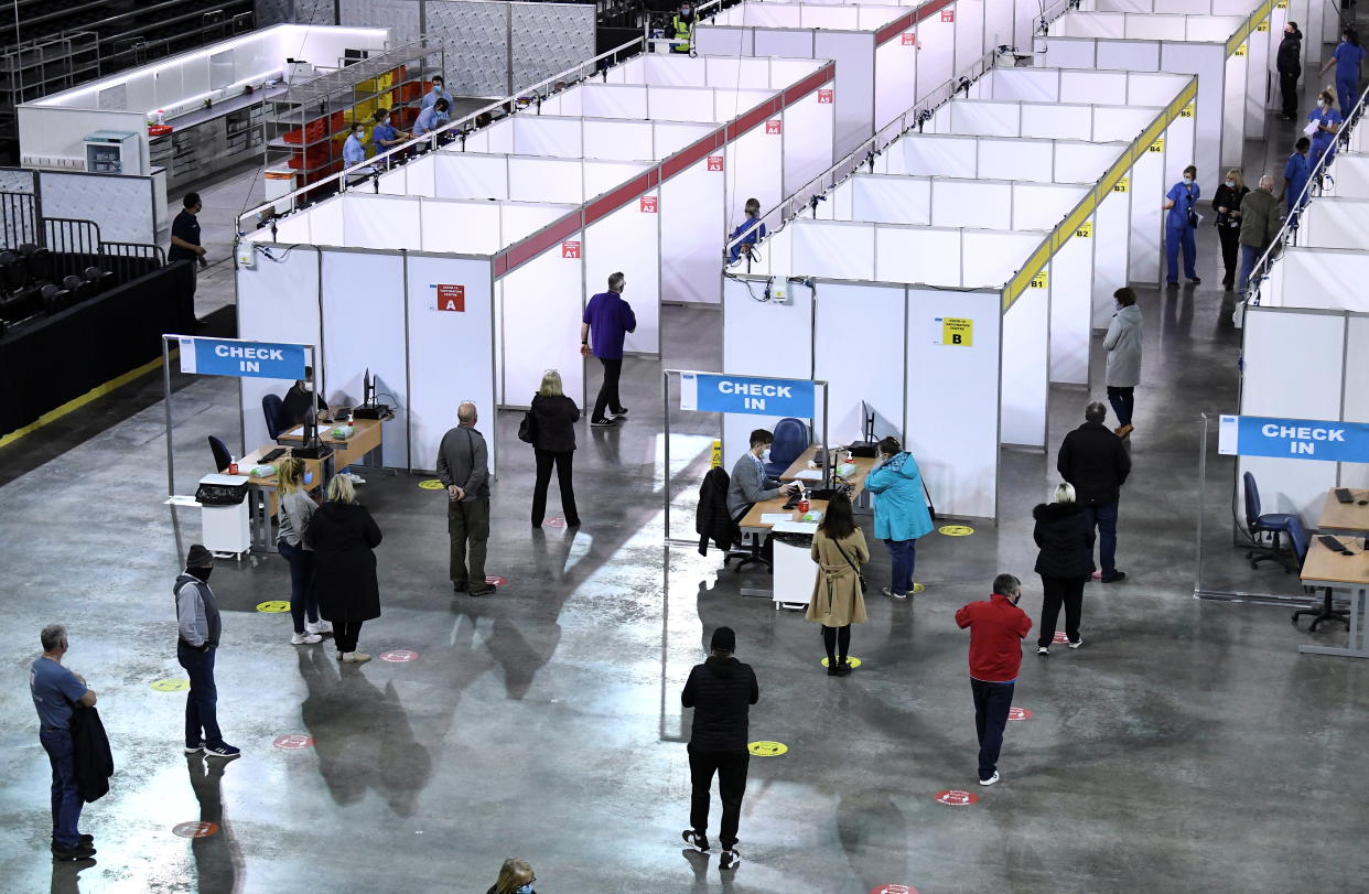 People queue for the AstraZeneca COVID-19 vaccine at the SSE Arena which opened this morning and will operate as a mega regional vaccination centre in Belfast, Northern Ireland March 29, 2021. REUTERS/Clodagh Kilcoyne