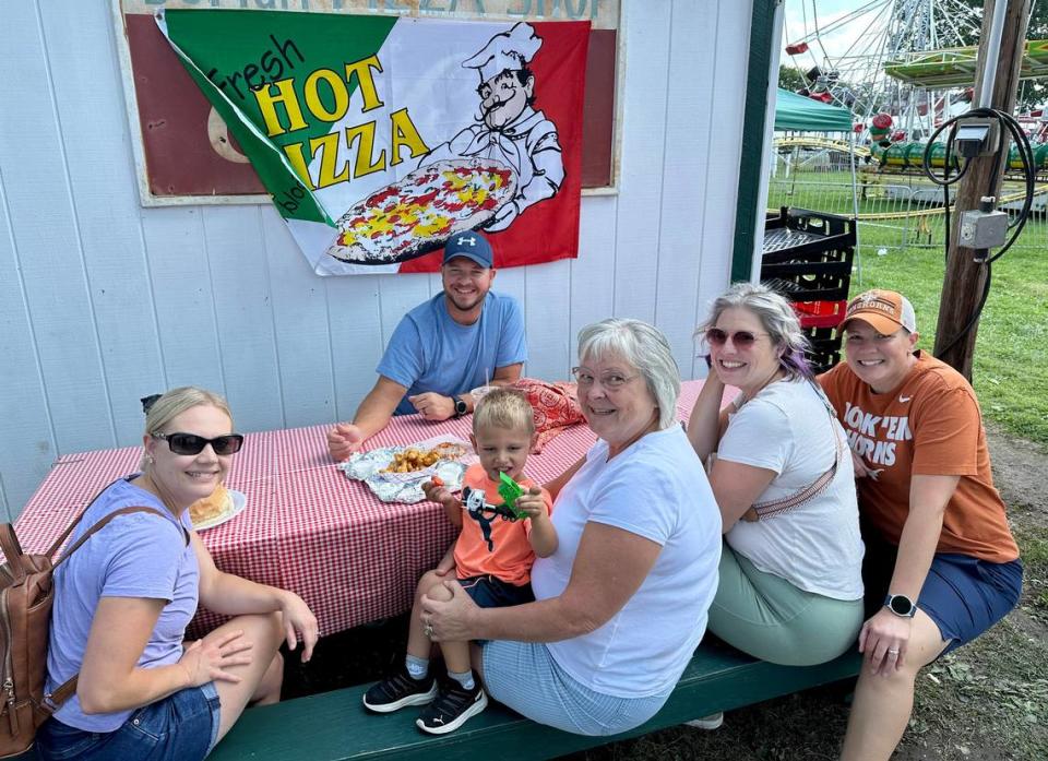 Georgina Knepp of Bellefonte and three generations of her family, including 3-year-old grandson Logan, have lunch at Grange Fair on Saturday, Aug. 19, 2023.