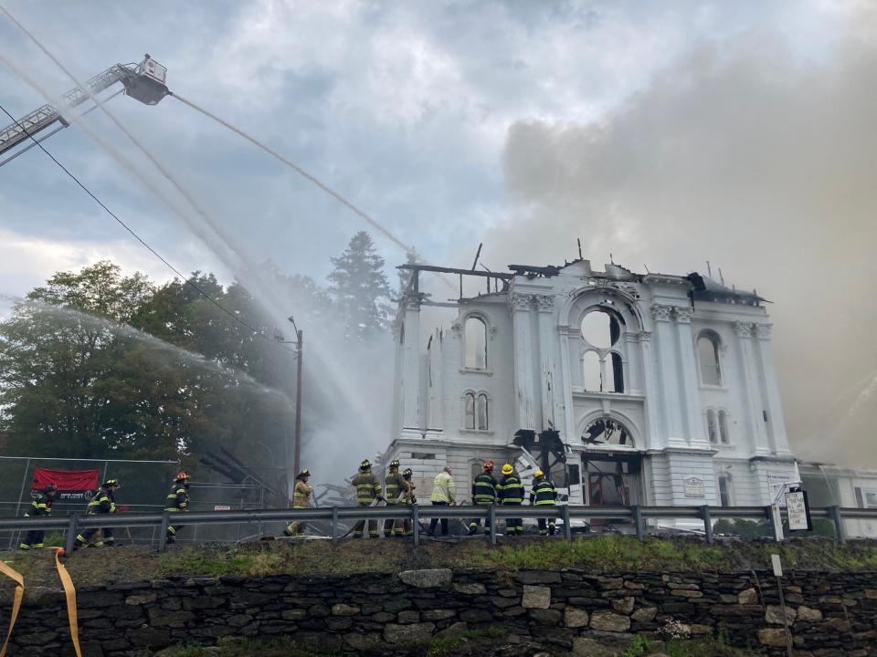 Fire crews battle the blaze Friday afternoon at the First Congregational Church in Spencer.