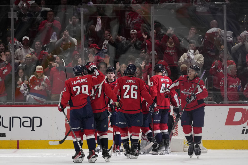 The Washington Capitals celebrate a 4-3 win over the Columbus Blue Jackets after an NHL hockey game in Washington, Saturday, Nov. 18, 2023. (AP Photo/Susan Walsh)