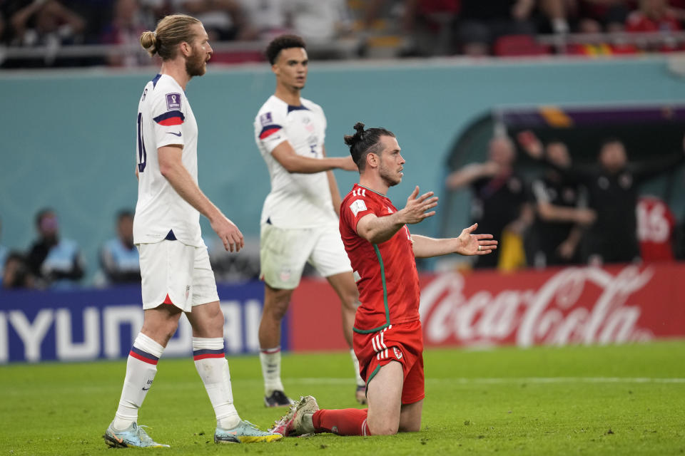 Wales' Gareth Bale reacts after a challenge during the World Cup, group B soccer match between the United States and Wales, at the Ahmad Bin Ali Stadium in in Doha, Qatar, Monday, Nov. 21, 2022. (AP Photo/Darko Vojinovic)
