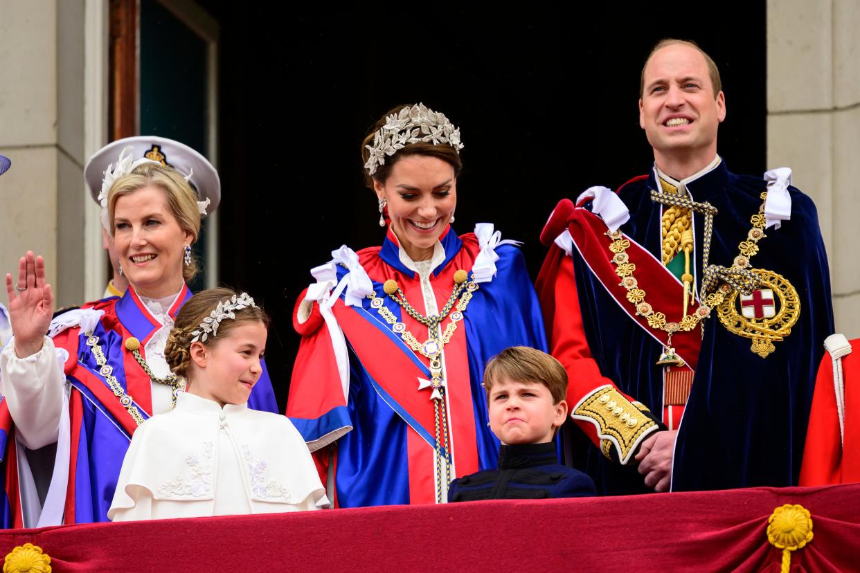 Sophie, Duchess of Edinburgh, left, Kate, Princess of Wales, centre, Prince William, right, stand on the balcony of Buckingham Palace with Princess Charlotte, down left, and Prince Louis, down center, during the coronation of Britain's King Charles III, in London, Saturday, May 6, 2023.
