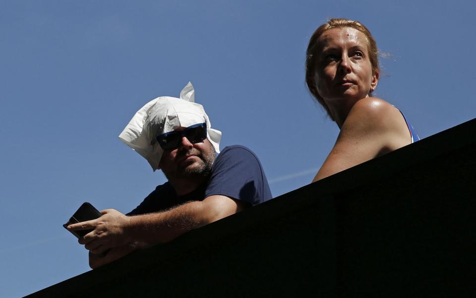 A man with a napkin on his head - Credit: ADRIAN DENNIS/AFP