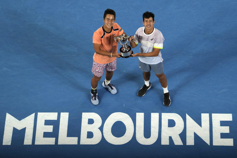 Rinky Hijikata, left, of Australia and compatriot Jason Kubler pose with their winners trophy after defeating Hugo Nys of Monaco and Jan Zielinski of Poland in the men's doubles final at the Australian Open tennis championship in Melbourne, Australia, Sunday, Jan. 29, 2023. (AP Photo/Ng Han Guan)