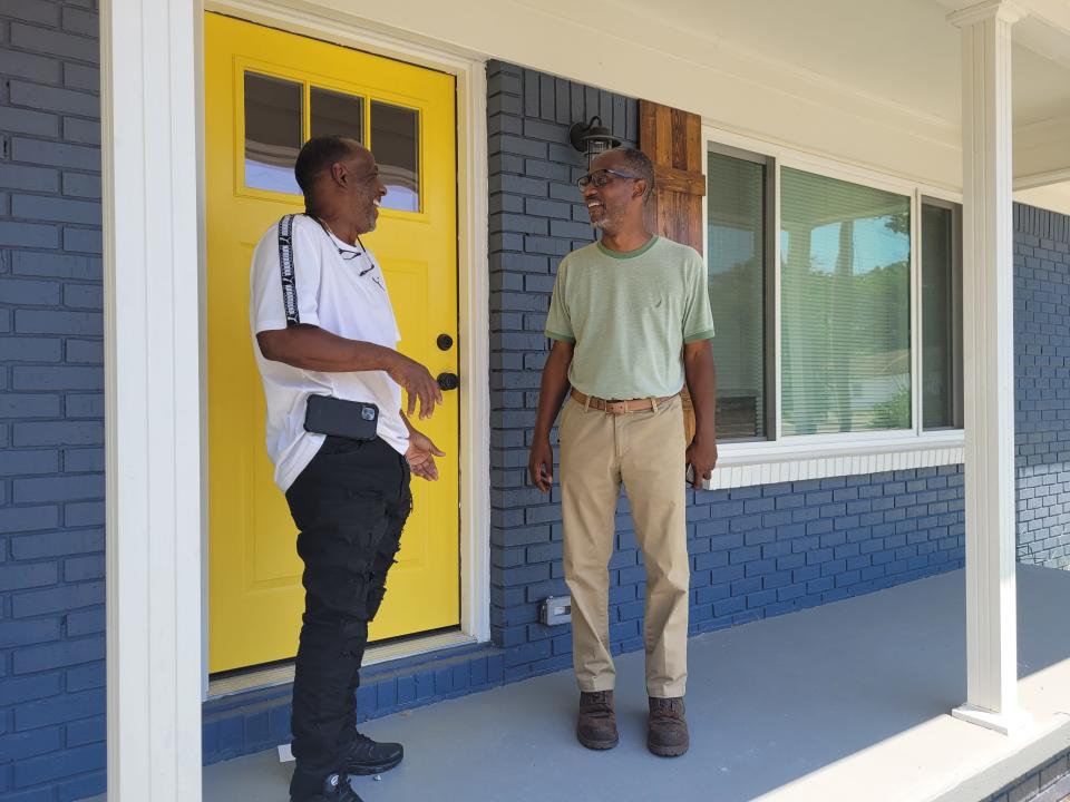 Brownsville Community Center manager Leroy Williams and Escambia County Commissioner Lumon May visit a home behind the center that was renovated by the county with the help of AMIkids to be an anchor for a possible new affordable housing development.