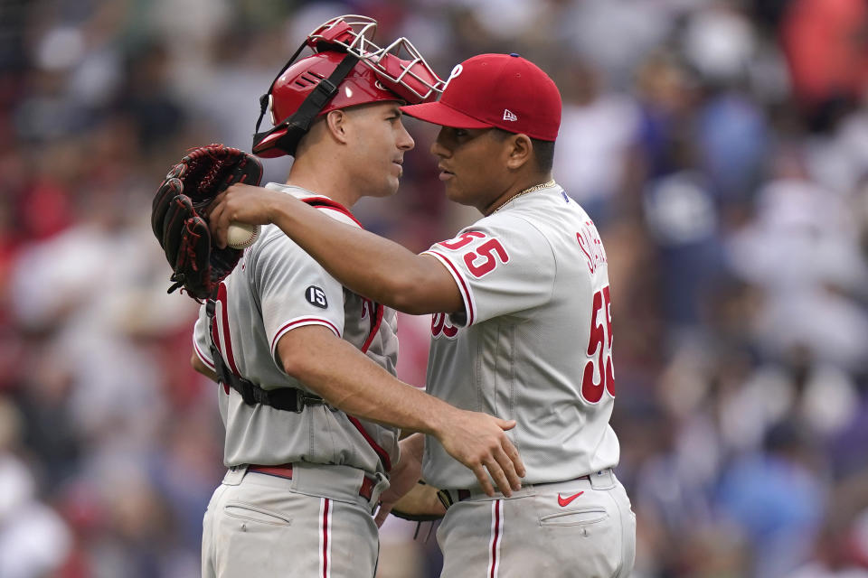 Philadelphia Phillies' J.T. Realmuto, left, celebrates with Ranger Suarez after they defeated the Boston Red Sox in a baseball game, Sunday, July 11, 2021, in Boston. (AP Photo/Steven Senne)