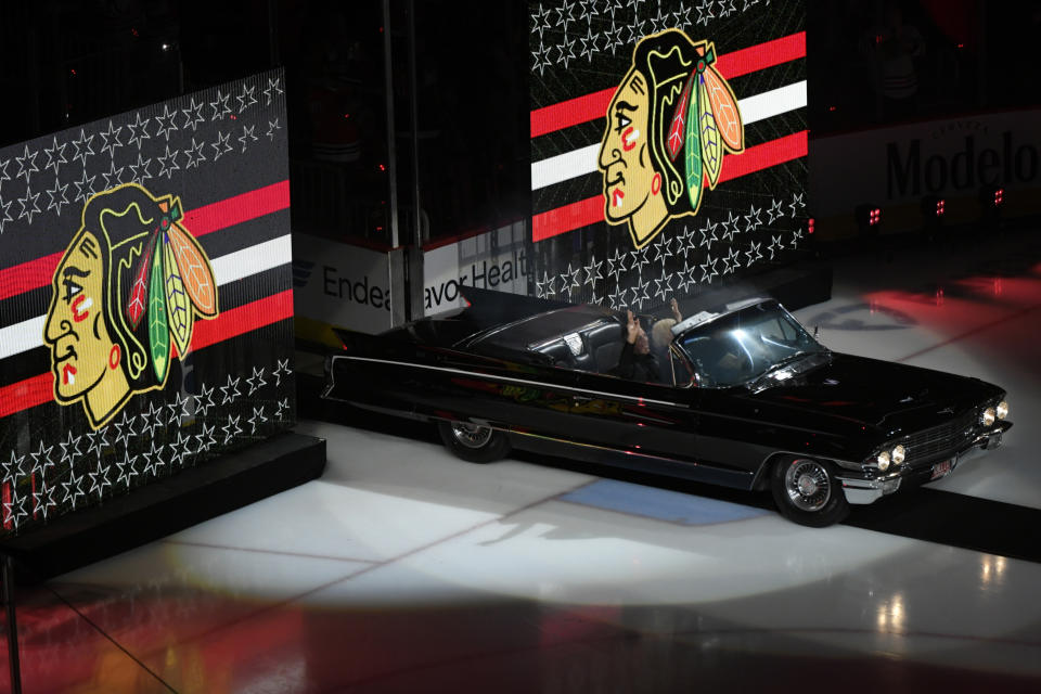 Former Chicago Blackhawks great Chris Chelios and his mother Susan ride in a car while entering the United Center during a ceremony to retire his jersey before an NHL hockey game between the Chicago Blackhawks and Detroit Red Wings Sunday, Feb. 25, 2024, in Chicago. (AP Photo/Paul Beaty)