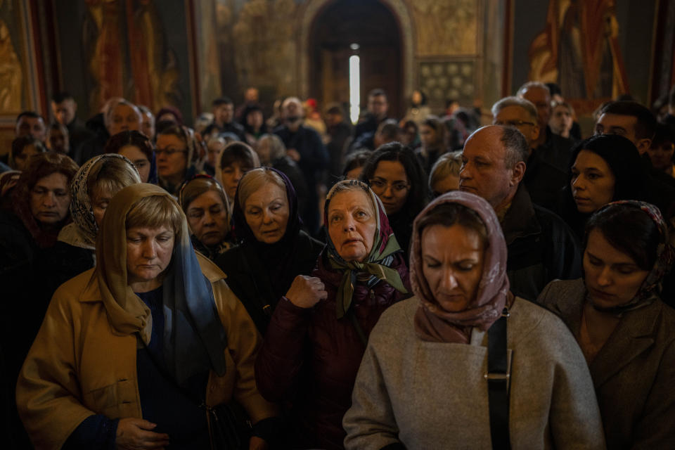 Orthodox Christian worshippers attend a Good Friday mass at St. Michael's Cathedral in downtown Kyiv, Friday, April 14, 2023. The mass was led by Metropolitan Ephipanius I, head of the Orthodox Church of Ukraine. (AP Photo/Bernat Armangue)