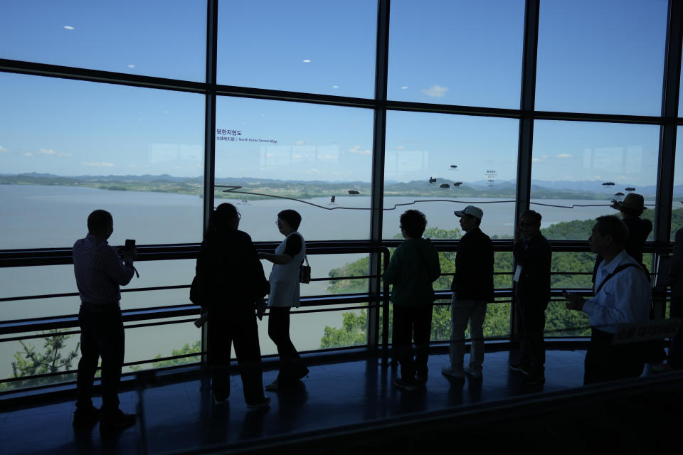 Visitors look at the North Korean side from the unification observatory in Paju, South Korea, Tuesday, May 28, 2024. A rocket launched by North Korea to deploy the country's second spy satellite exploded shortly after liftoff Monday, state media reported, in a setback for leader Kim Jong Un's hopes to operate multiple satellites to better monitor the U.S. and South Korea. (AP Photo/Lee Jin-man)