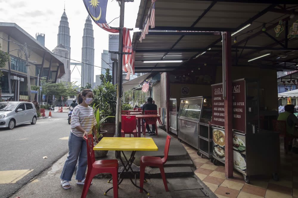 Warung Perasan owner Safinaz arranges seats at her eatery in Kampung Baru, Kuala Lumpur October 27, 2020. — Picture by Firdaus Latif