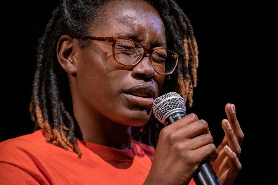 Rachel Jackson, part of the Saint Louis Story Stitchers artistic collective, delivers an original poem about the impact of gun violence at the Grandel Theatre in St. Louis on Aug. 13.