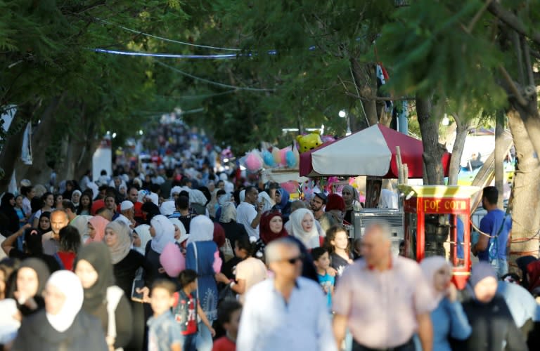 Syrians attend a government-sponsored summer festival in the capital Damascus, on July 11, 2018