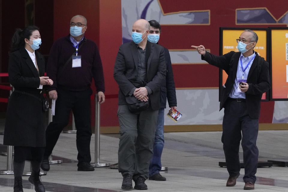 Members of the World Health Organization team including Ken Maeda right, Peter Daszak, third from left and Vladmir Dedkov, fourth from left, leave after attending an exhibition about the fight against the coronavirus in Wuhan in central China's Hubei province on Saturday, Jan. 30, 2021. The World Health Organization team investigating the origins of the coronavirus pandemic visited another Wuhan hospital that had treated early COVID-19 patients on their second full day of work on Saturday. (AP Photo/Ng Han Guan)