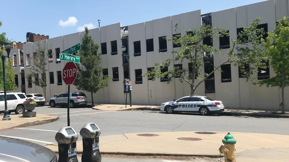 An APD cruiser idles outside Wall Street Garage in downtown Asheville on June 9, 2023.