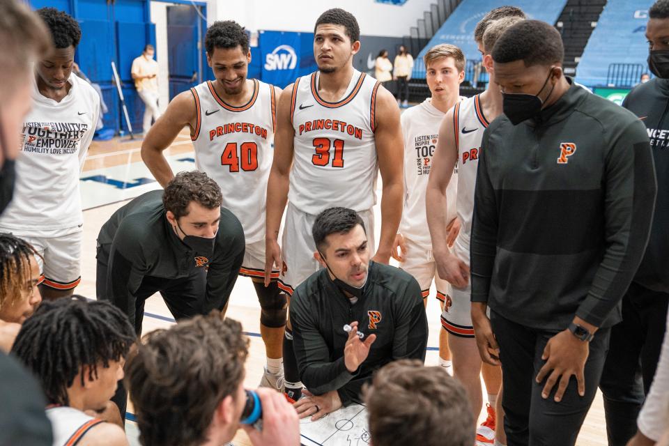 Brett MacConnell (center) coaches Princeton basketball during a 2022 game when he filled in for a sick Mitch Henderson