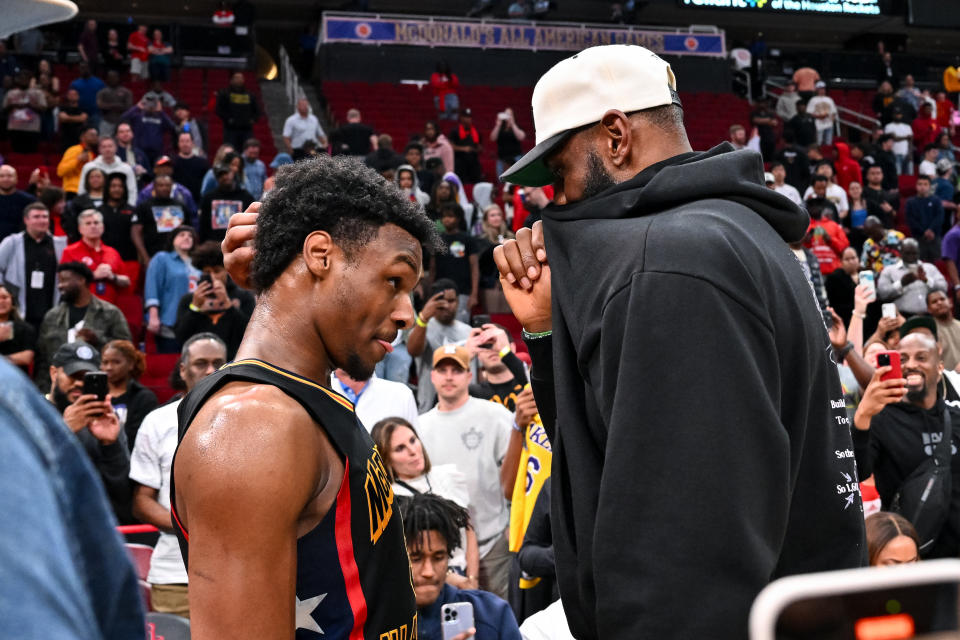 Mar 28, 2023; Houston, TX, USA; McDonald’s All American West guard Bronny James (6) speaks with his father, LeBron James of the Los Angeles Lakers, after the game against the McDonald’s All American East at Toyota Center. Mandatory Credit: Maria Lysaker-USA TODAY Sports