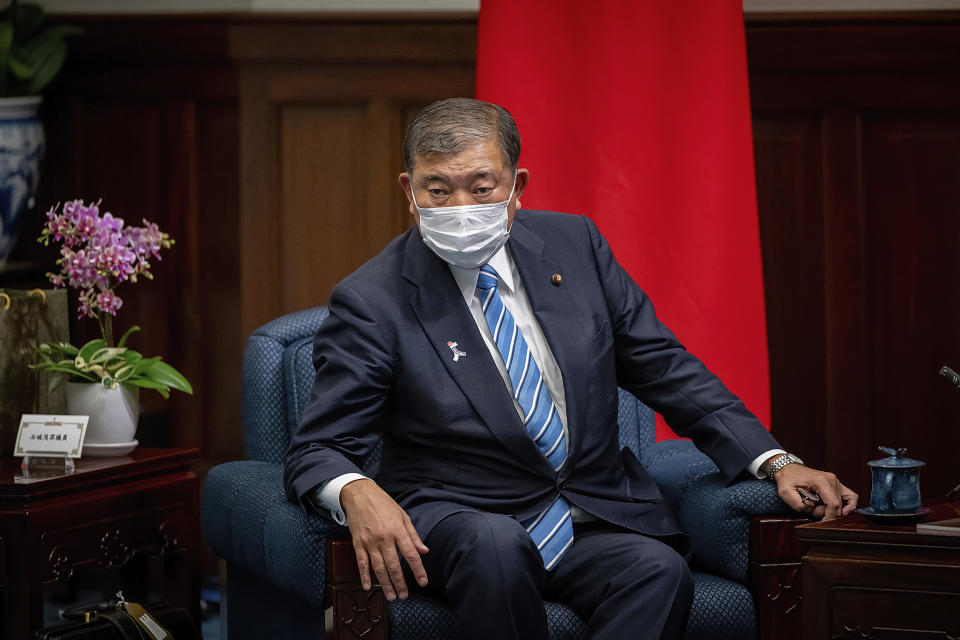 In this photo released by the Taiwan Presidential Office, Japanese lawmaker and former Defense Minister Shigeru Ishiba wears a mask during a meeting with Taiwan's President Tsai Ing-wen at the presidential office in Taipei, Taiwan Thursday, July 28, 2022. The group of Japanese lawmakers including two former defense ministers met with Taiwan's president on Thursday in a rare high-level visit to discuss regional security. (Taiwan Presidential Office via AP)