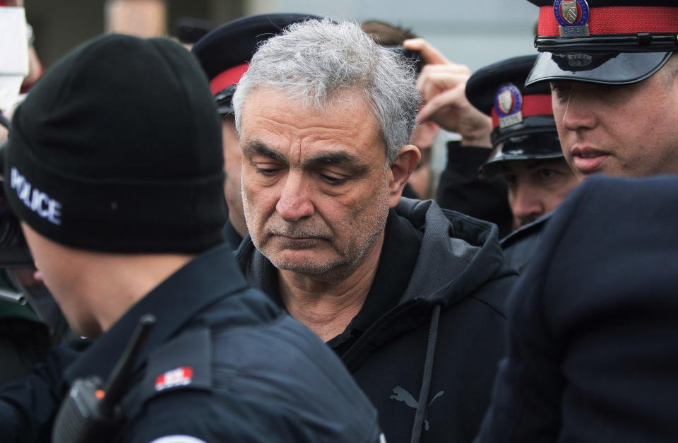 <p>Vahe Minassian, father of Alek Minassian, is surrounded by members of the media as he leaves court with a police escort in Toronto on Tuesday, April 24, 2018. (Photo: Chris Young/The Canadian Press via AP) </p>