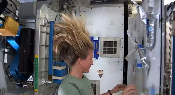 NASA astronaut Karen Nyberg shows how she washes her hair in space in this still from a video recorded on the International Space Station and uploaded online on July 9, 2013.