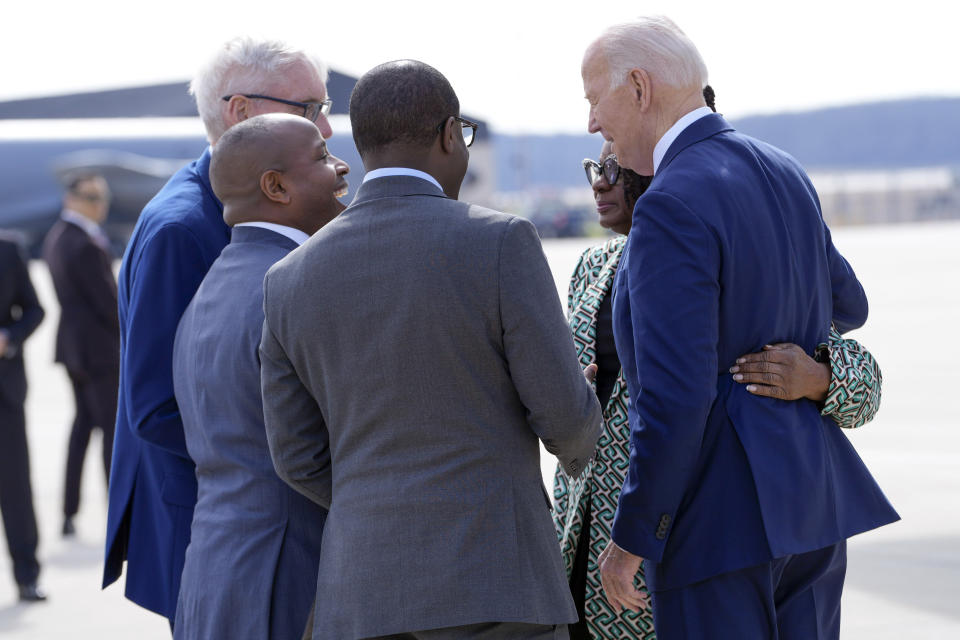 President Joe Biden talks with, from left, Wisconsin Gov. Tony Evers, Milwaukee Mayor Cavalier Johnson, Milwaukee County Executive David Crowley and Rep. Gwen Moore, D-Wis., as he arrives in Milwaukee, Wednesday, March 13, 2024, at the Milwaukee International Airport Air National Guard Base. (AP Photo/Jacquelyn Martin)