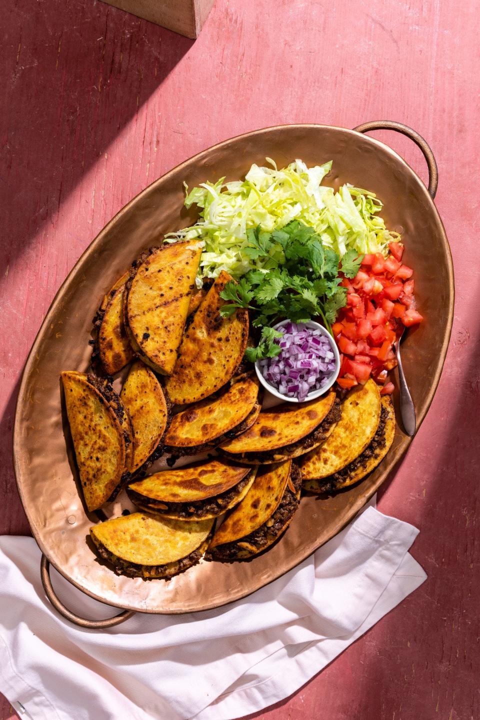 Crispy Fried Tacos with Almond and Raisins are made with plant-based meat that is seasoned.