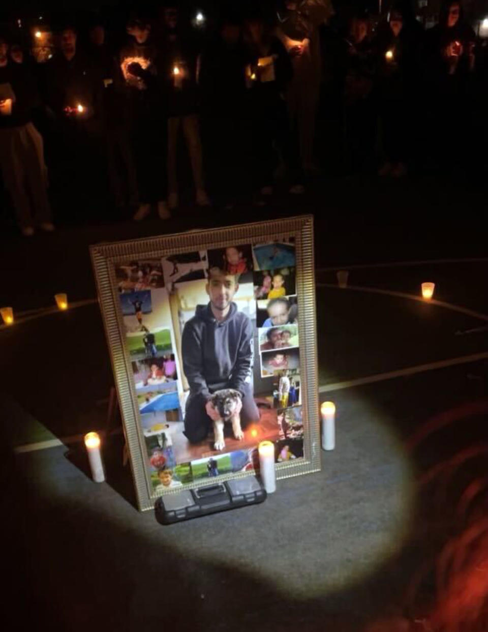 Photos of Jorge Reyes-Jungwirth, 20, at a candlelight vigil Monday night in Eagan, Minn. (Jack Heidelberg)