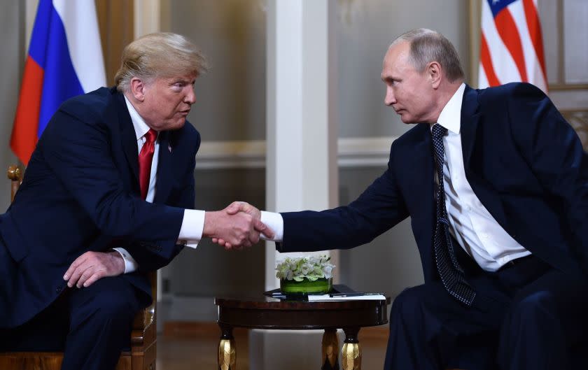 Trump and Putin shake hands ahead of their private meeting on Monday. Before their one-on-one session, Trump said to Putin, "We have a lot of questions, and hopefully we'll come up with answers. It's great to be with you."