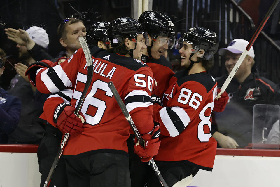 FILE - New Jersey Devils defenseman Damon Severson (28) celebrates with teammates after scoring a goal against the Edmonton Oilers during the second period of an NHL hockey game Monday, Nov. 21, 2022, in Newark, N.J. The New Jersey Devils cannot sneak up on teams anymore. The once-laughable also-rans have gone from a team that has missed the Stanley Cup playoffs nine of the last 10 years to currently the NHL's hottest team. (AP Photo/Adam Hunger, File)