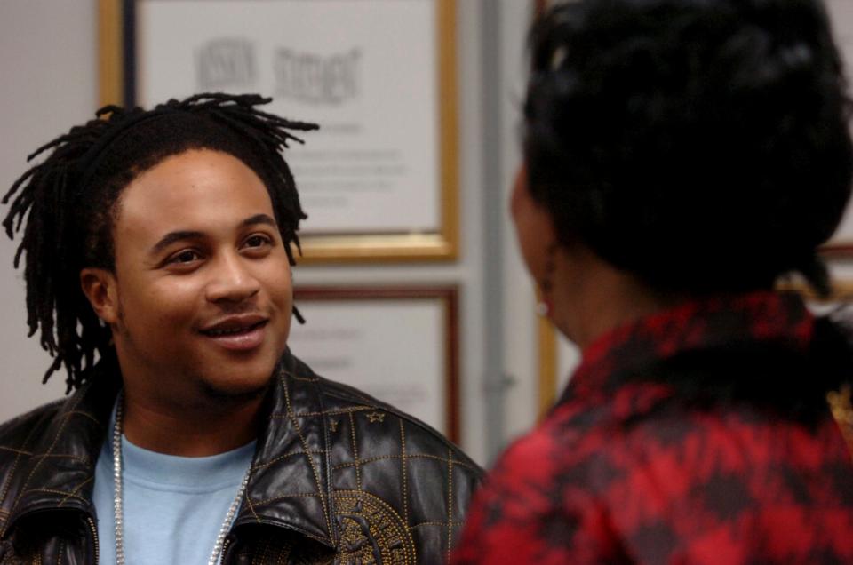 Orlando Brown, left, talks with Smith Middle School principal Carol Batiste at the school in Beaumont, Texas, in 2007. The actor/rapper was arrested earlier this week on a misdemeanor domestic violence charge.