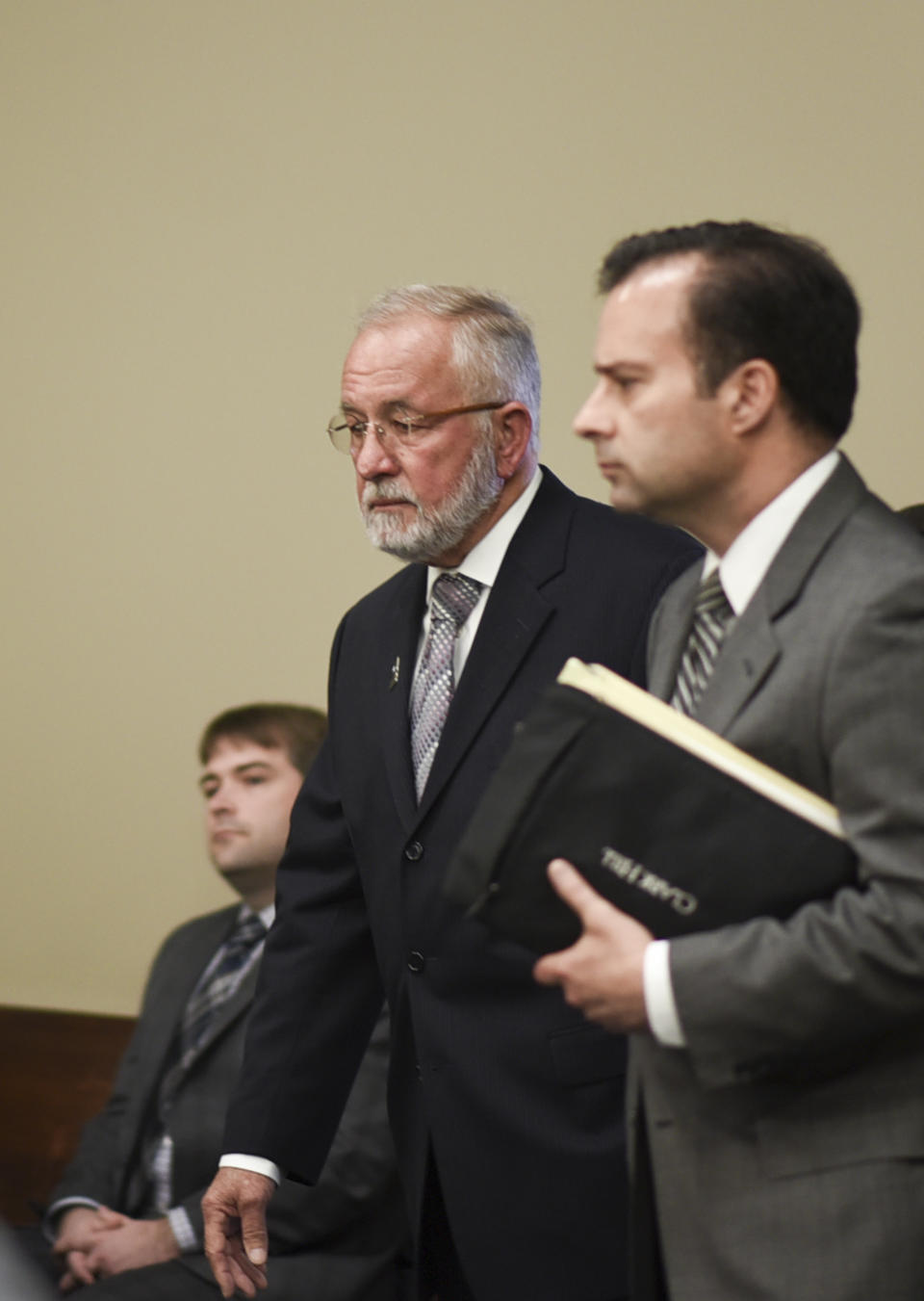 William Strampel, left, former dean at the College of Osteopathic Medicine at Michigan State University in East Lansing, Michigan, enters Ingham County Circuit Court Wednesday, June 12, 2019, with his attorney John Dakmak. Strample was found guilty Wednesday of neglect of duty and misconduct in office but acquitted on a more serious criminal sexual conduct charge. (Matthew Dae Smith/Lansing State Journal via AP)