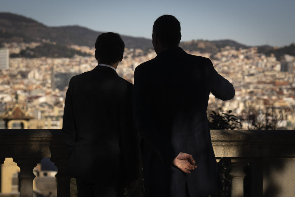 French President Emmanuel Macron, left, talks with Spanish counterpart Pedro Sánchez as they look over Barcelona, Spain, on Thursday, Jan. 19, 2023. A summit between the Spanish and French governments, led by their executive leaders, prime minister Pedro Sánchez and president Emmanuel Macron, is held in the capital of Catalonia to strengthen relations between the European neighbors by signing a friendship treaty. (AP Photo/Emilio Morenatti)