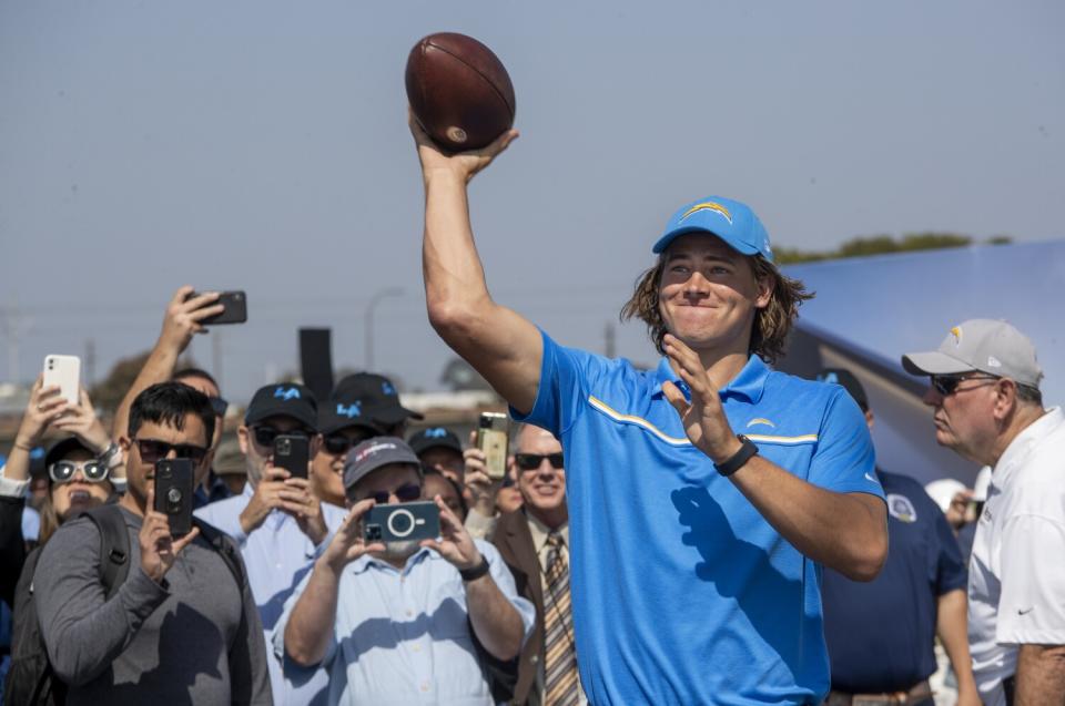 Justin Herbert throws the first pass on grounds that will become the Chargers' future headquarters in El Segundo.