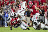 Georgia running back Zamir White (3) is tackled by South Carolina defensive back R.J. Roderick (10) and defensive back Jaylan Foster (12) during the first half of an NCAA college football game Saturday, Sept. 18, 2021, in Athens, Ga. (AP Photo/Butch Dill)