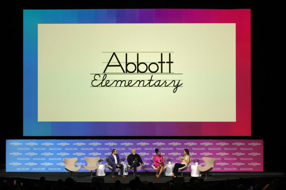 Quinta Brunson dressed in a pink suit speaks during a panel about Abbott Elementary.