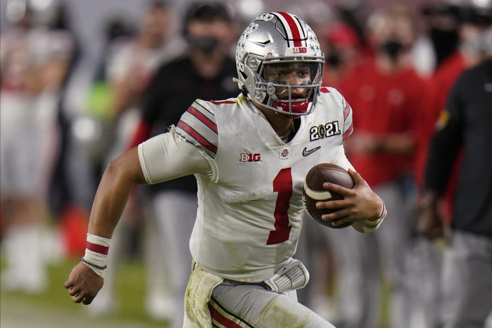 Ohio State quarterback Justin Fields runs against Alabama during the second half of an NCAA College Football Playoff national championship game, Monday, Jan. 11, 2021, in Miami Gardens, Fla. (AP Photo/Chris O'Meara)