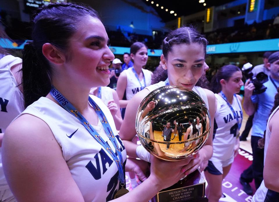 Putnam Valley's Brianna Foody (22) and Naieliz Torres (3) hold the Gold Ball trophy after defeating Westlake 48-37 in the Section 1 Class B girls basketball championship game at the Westchester County Center in White Plains on Friday, March 1, 2024.